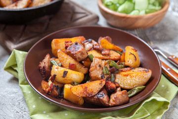 Fried roasted potatoes with pork meat, green bean, bacon and onion