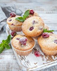 Baked Raspberry Muffins on a old white wooden table