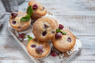 Baked Raspberry Muffins on a old white wooden table