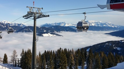 Ski Lift above Clouds between snow-topped mountains  © MattRHD