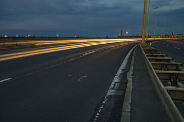 Fototapeta premium The road leading to Szczecin after sunset, traces of lights of cars