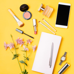 Modern woman accessories. Beauty products, smartphone, note book, accessories on a pastel background