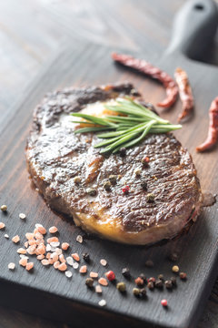 Beef steak with fresh rosemary on the wooden board