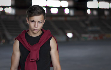 Serious young man in an old stadium, portrait