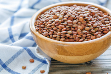 Dry lentils in a wooden bowl.