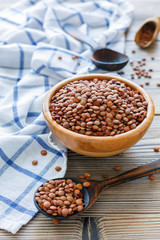 Bowl and spoon with brown lentils.