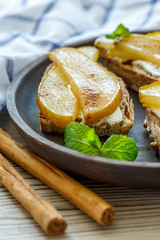 Crostini with soft cheese and caramelized pear.