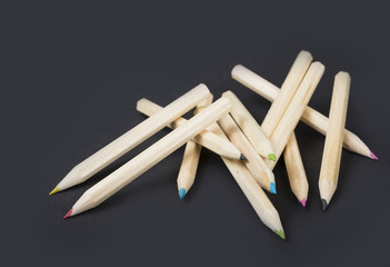 Back to school and classroom supplies with closeup on mix colored pencils on black background