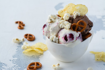 Chocolate and vanilla ice cream with berries, bretzel, salty popcorn and potato chips. Space for text