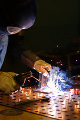 Worker produces arc welding products