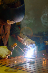 Worker produces arc welding products
