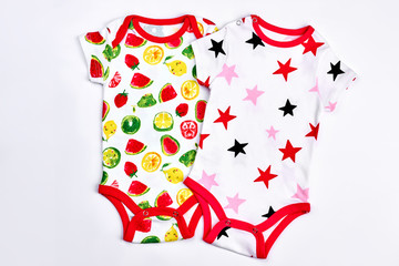 Set of beautiful babies bodysuits. Newborn baby new cotton printed bodysuits, white background. High quality babies rompers on sale.