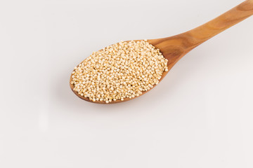 Pile of grain quinoa seeds in spoon