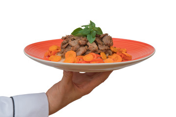 meat dish on a plate in the hand of the cook
