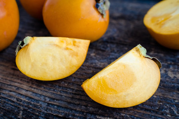 Delicious fresh persimmon fruit on wooden table