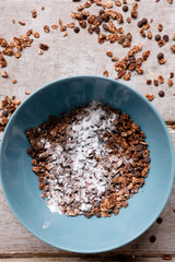 Healthy cereal breakfast on wooden background. Sweet granola in teal bowl. Wholegrain vegetarian morning tasty food.