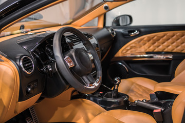 Luxury car Interior - steering wheel, shift lever and dashboard.