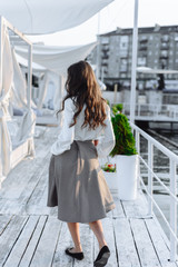 Fototapeta premium fashion portrait of happy beautiful girl in white shirt and casual dress