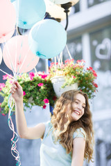  beautiful woman with flying multicolored balloons