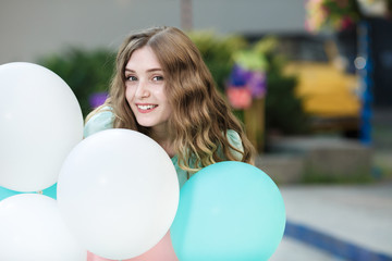 Naklejka premium beautiful woman with flying multicolored balloons