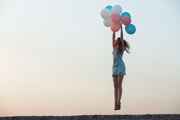  beautiful woman with flying multicolored balloons 