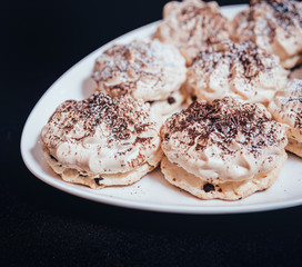 French meringue cookies on the white plate.
