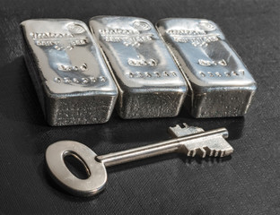 Cast silver bars and the key to the safe.