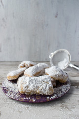 Homemade beignets with powdered sugar in rustic setting
