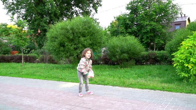 little girl playing with plastic bag