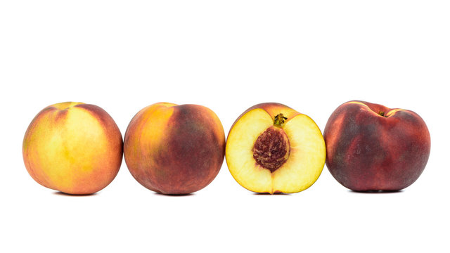 Ripe peaches in a row on white background