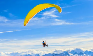 Tuinposter Paragliding over the mountains in winter. Ski resort  Hopfgarten, Tyrol, Austria © Nikolai Korzhov