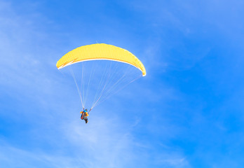 Paragliding over the mountains in winter. Ski resort  Hopfgarten, Tyrol, Austria