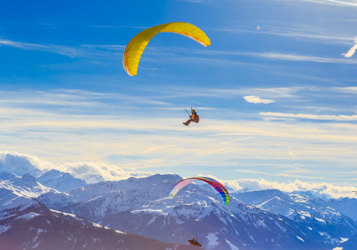 Paragliding over the mountains in winter. Ski resort  Hopfgarten, Tyrol, Austria