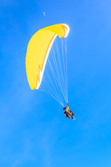 Paragliding over the mountains in winter. Ski resort  Hopfgarten, Tyrol, Austria