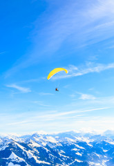 Paragliding over the mountains in winter. Ski resort  Hopfgarten, Tyrol, Austria