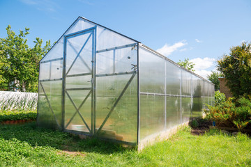Greenhouse made of polycarbonate with a triangular roof
