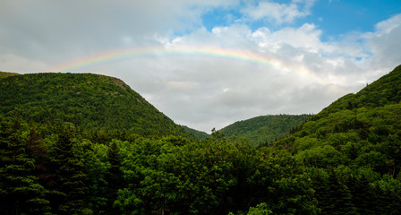 Fototapeta na wymiar Rainbow over mountains