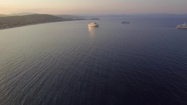 Aerial view of big motor yacht with helicopter place/ Drone flying over it