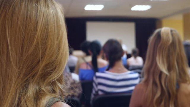 Audience at the conference, back view. 4k, slow motion.
