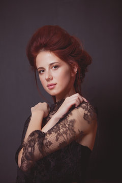 Young redhead woman in black dress