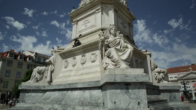 The twenty-three meter tall column with a statue of Dom Pedro IV in Praca Dom Pedro IV or Rossio Square in Lisbon downtown, Portugal, Europe. Sunny day in blue sky. Turn around view.