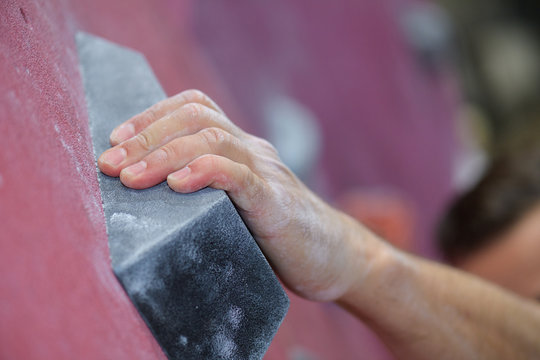 Climber Hands Holding Artificial Boulder In Climbing Gym Closeup Shot