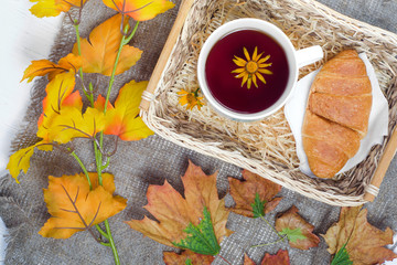Autumn leaves croissant cup of tea basket