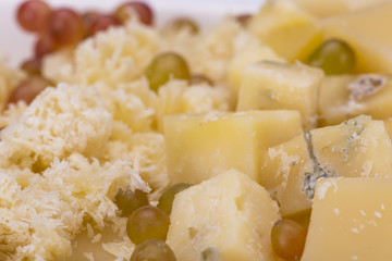 Set of cheeses and grapes on a white background