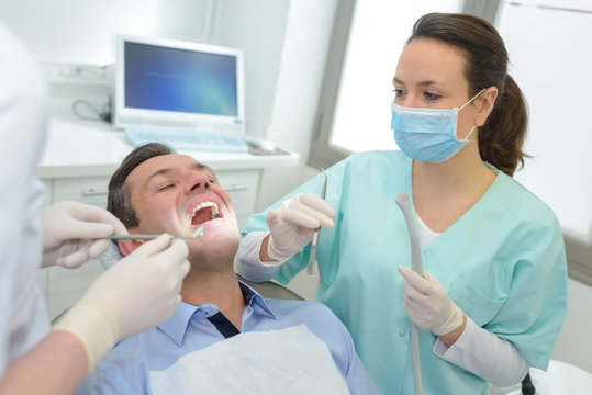 dentist is checking up a patient