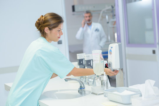 beautiful nurse washes hands