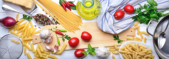 Pasta and ingredients: spaghetti, pens, tortiglioni and fusilli, tomatoes, parmesan, chili peppers,...