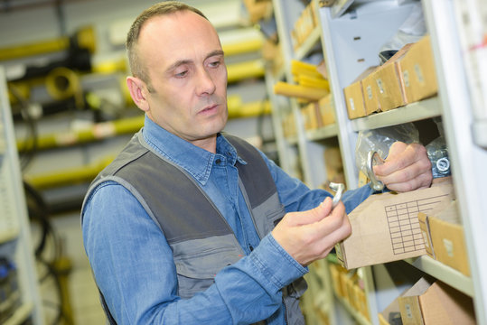 middle-age man choosing tools in household store
