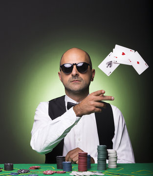 Poker player throwing cards at the poker table