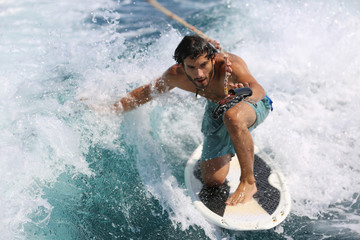 Young man surfing on the wave.